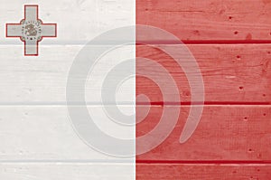 Malta flag painted on wood plank background. Wooden texture flag of Malta