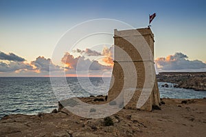 Malta - Ghajn Tuffieha watchtower at Golden Bay before sunset