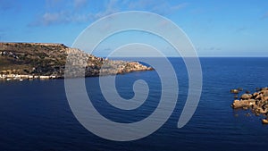 Malta, Gnejna bay aerial view of the sea, horizon and rugged peninsula, Mgar, Maltese island in Mediterranean Sea photo