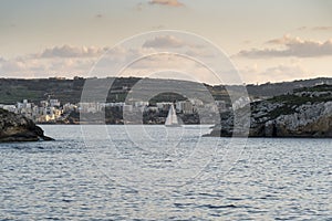 Sail boat between St Paul`s Island and St Pauls Bay Malta