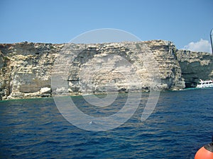 Malta limestone steep shore with geomorphological layers een from the sea photo