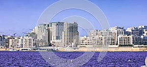 Malta Valletta. Modern Sliema multi-storey buildings, blue sea and sky background