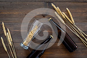 Malting barley. Grains and ears on dark wooden background top view copyspace