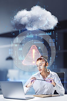 Malware and system error concept with young woman in white shirt looking at laptop monitor and abstract digital data cloud network
