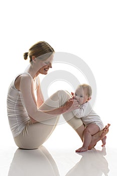 Mama does gymnastics with baby