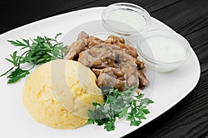 Mamaliaga or polenta with cheese and beef meat. Traditional food of Moldovan and Romanian.