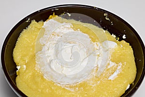 (Mamaliga) with cheese, eggs, and cream