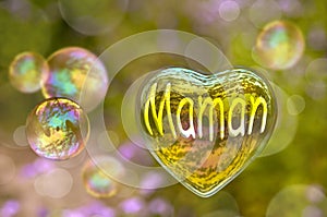 Maman (meaning mom in French) written on a soap bubble in the shape of heart