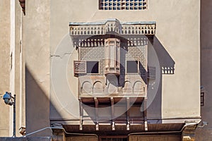 Mamluk era style oriel windows with interleaved wooden grid - Mashrabiya, on shabby wall photo