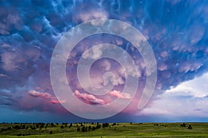 Mammatus clouds and stormy sky at sunset.