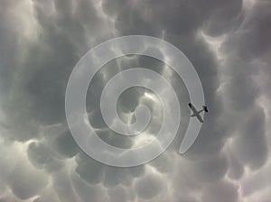 Mammatus Dark Storm Clouds and Lite Plane photo