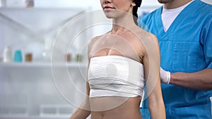 Mammologist bandaging female chest to dry up breast milk, negative result risk