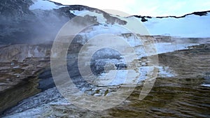 The mammoth hot spring in north Yellowstone national park in the evening in the winter with snow