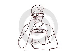 Man in 3D glasses eating popcorn