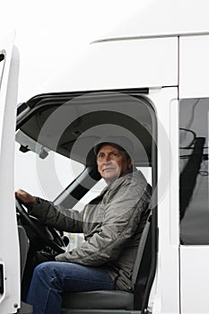 Man 50 years behind steering wheel of white car