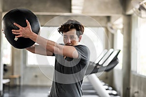 man abdomen exercise with hard ball in gym