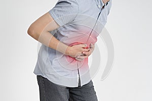 Man with abdominal pain, stomach ache on gray background