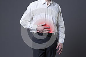Man with abdominal pain, stomach ache on gray background