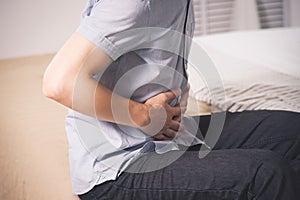 Man with abdominal pain suffering at home