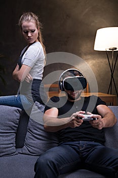 Man absorbed by game with angry girlfriend photo