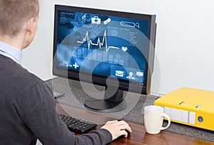 Man accessing medical data on computer