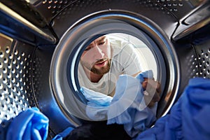 Man Accidentally Dyeing Laundry Inside Washing Machine photo