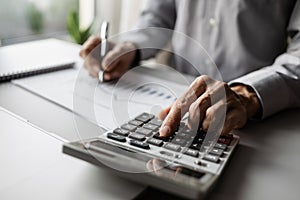 Man accountant using calculator and computer in office, businessman working at home, finance and accounting concept