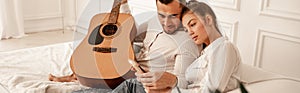 man with acoustic guitar looking at