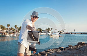 Man with action camera take a selfie photo in the tropical sea b