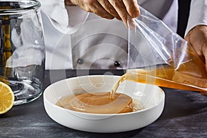 Man activating the mother, fungus or scoby photo