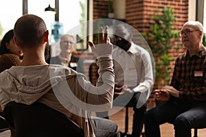 Man with addiction sharing health problems with group at aa meeting photo