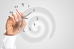 Man adding a second hand to a hand-drawn clock