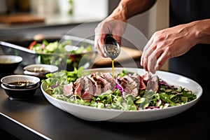 a man adding a side salad to his sesame tuna steak dish