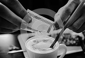 Man adding sugar to the coffee photo