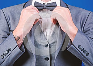 Man adjust suit with bow tie. Formal suit jacket close up. Male fashion and aesthetic. Businessman formal outfit