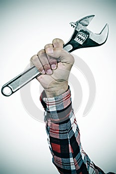 Man with adjustable wrench in his hand, vignette added