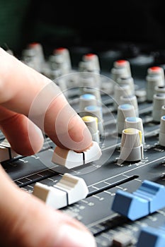 Man adjusting audio mixer photo
