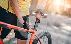 Man adjusting bicycle seat height