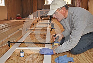 Man adjusting clamps on trim assembly photo