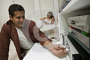 Man Adjusting Dial on Stereo system