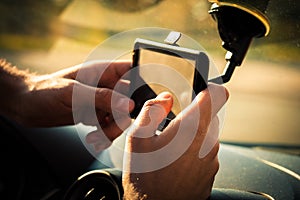 Man adjusting gps in car