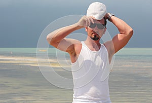 Man adjusting hat.