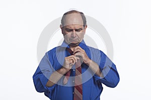 Man adjusting his tie, horizontal