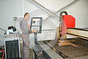 Man adjusting plasma cutting machine