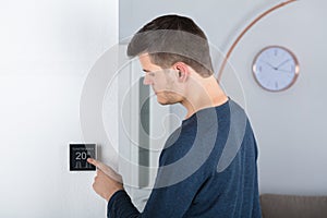 Man Adjusting Room Temperature