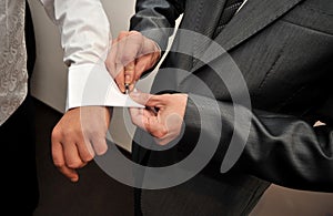 Man adjusting sleeve cuff