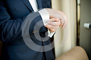 Man adjusting sleeve cuff