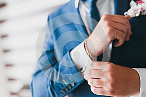 Man adjusting sleeve cuff