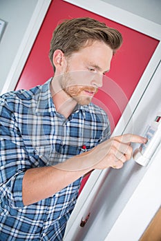 Man adjusting temperature electric boiler