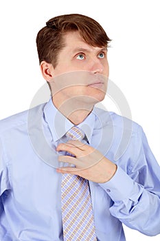 Man adjusts blue tie isolated on white